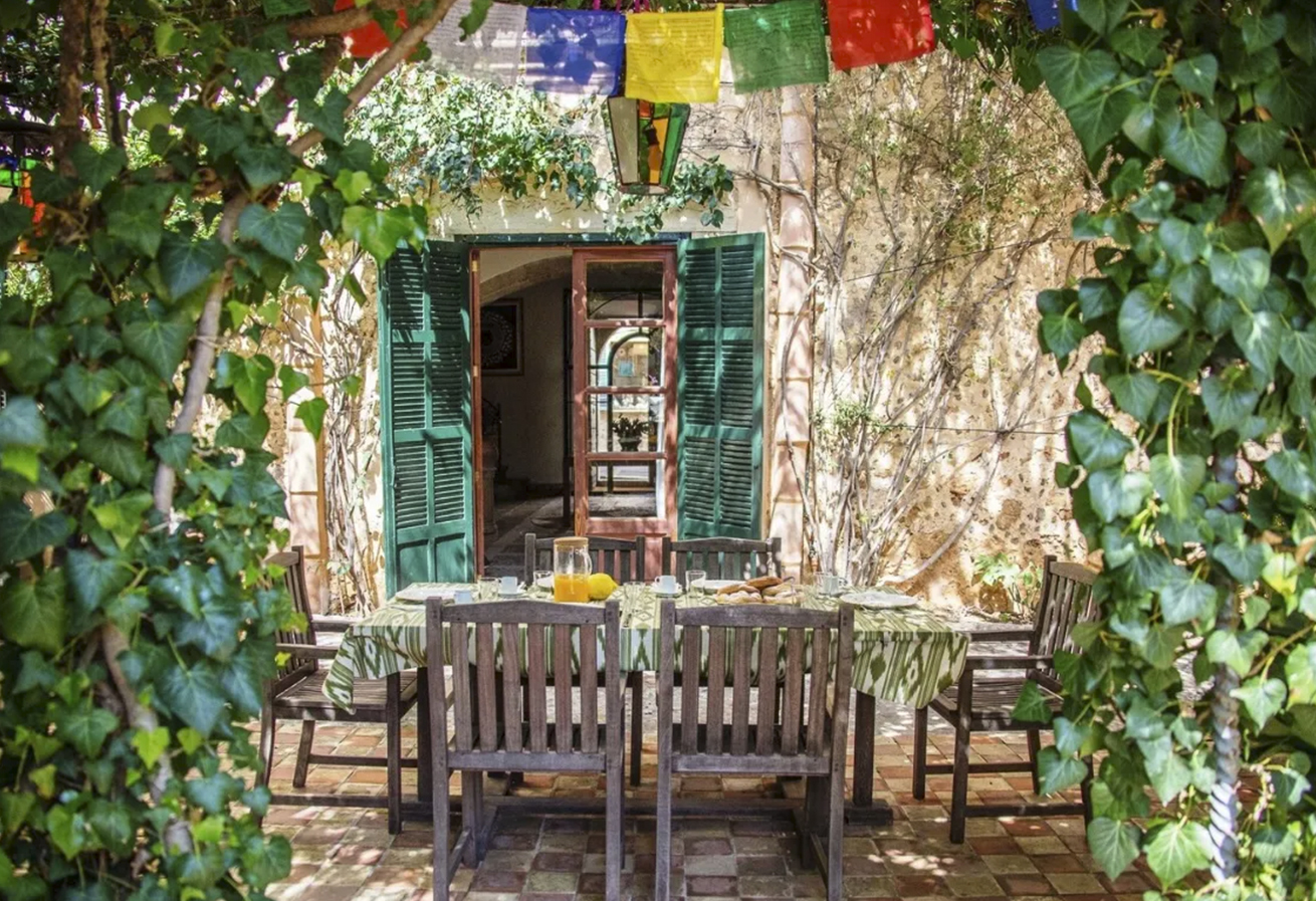 Outdoor dining area shaded by greenery
